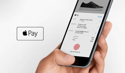 A person validating the Apple Pay payment method with a fingerprint.